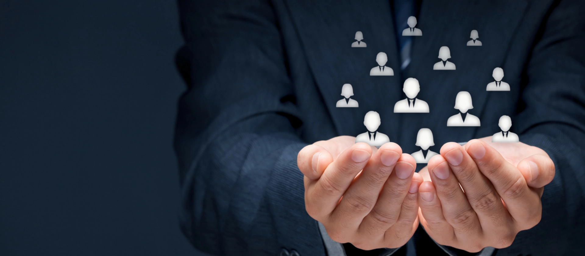 Symbolic image for AML customer segmentation: Businessperson holding abstract customer icons in cupped hands – representing protection and dynamic clustering for improved anti-money laundering monitoring.